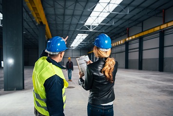 Commercial maintenance contractor inspecting office interior
